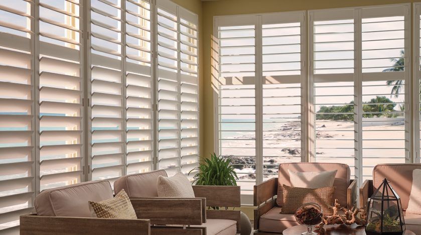 Custom indoor shutters allow view of beach
